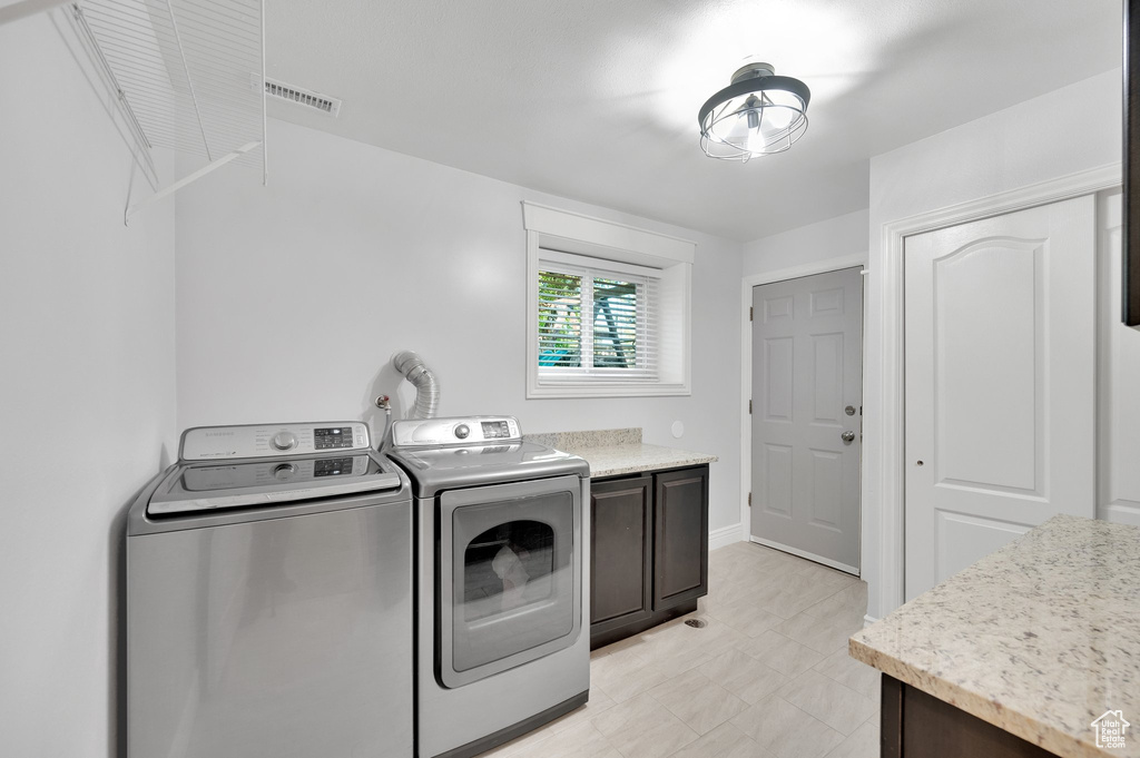 Laundry room featuring washing machine and dryer and cabinet space