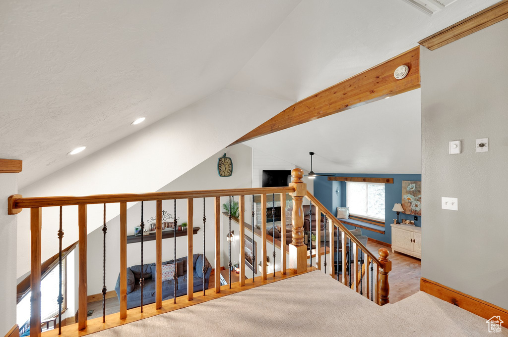 Stairway featuring vaulted ceiling, recessed lighting, baseboards, and wood finished floors