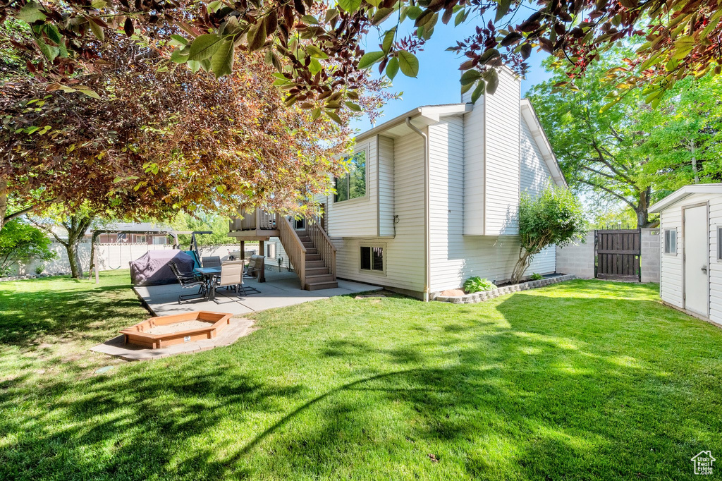 Rear view of house with a chimney, stairs, and a patio