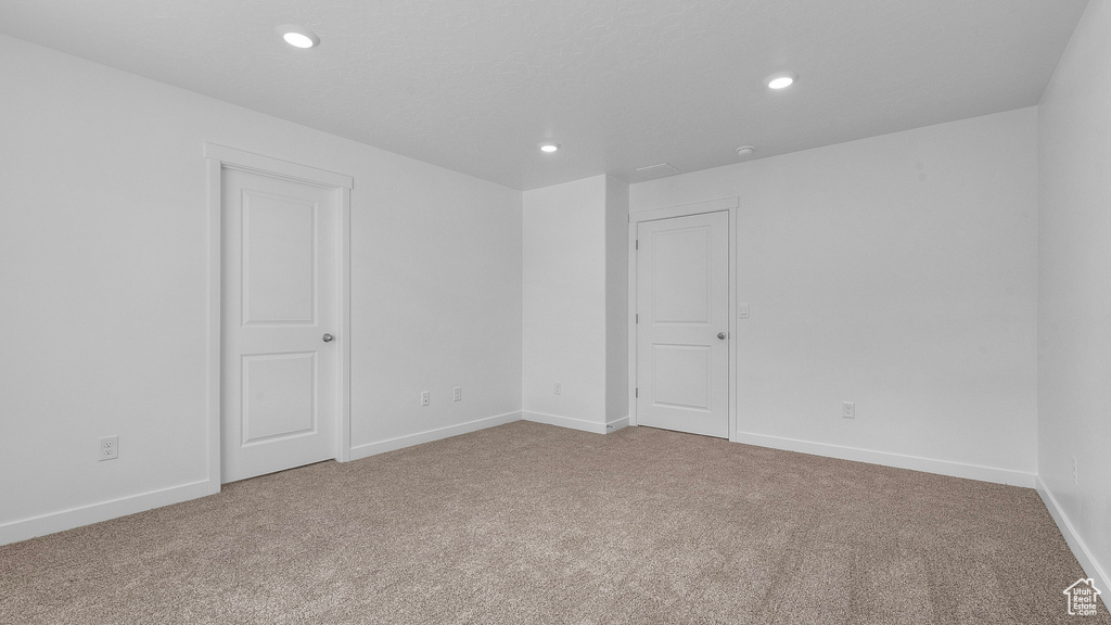 Unfurnished room featuring carpet flooring, recessed lighting, and baseboards