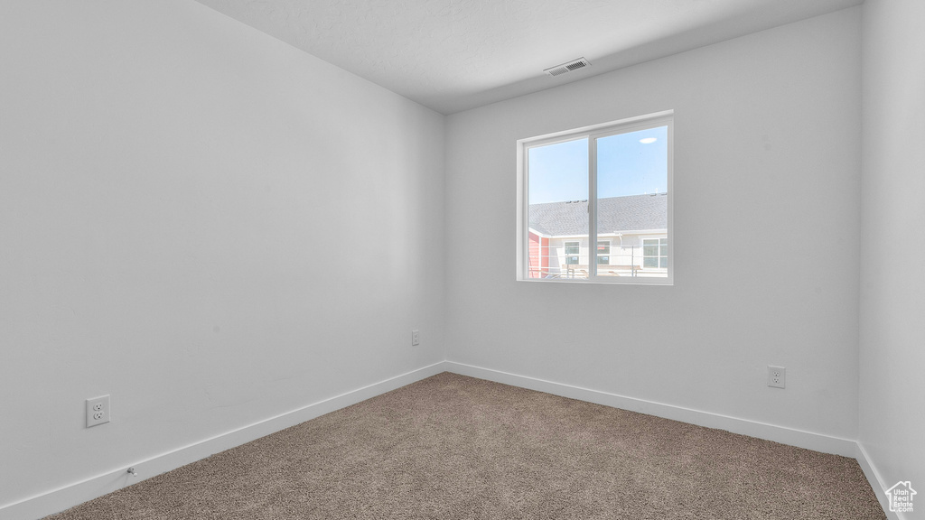 Unfurnished room with carpet flooring and baseboards
