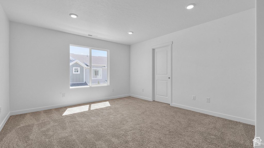Unfurnished room with carpet floors, baseboards, and recessed lighting