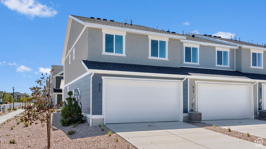 View of front of house featuring a garage and concrete driveway