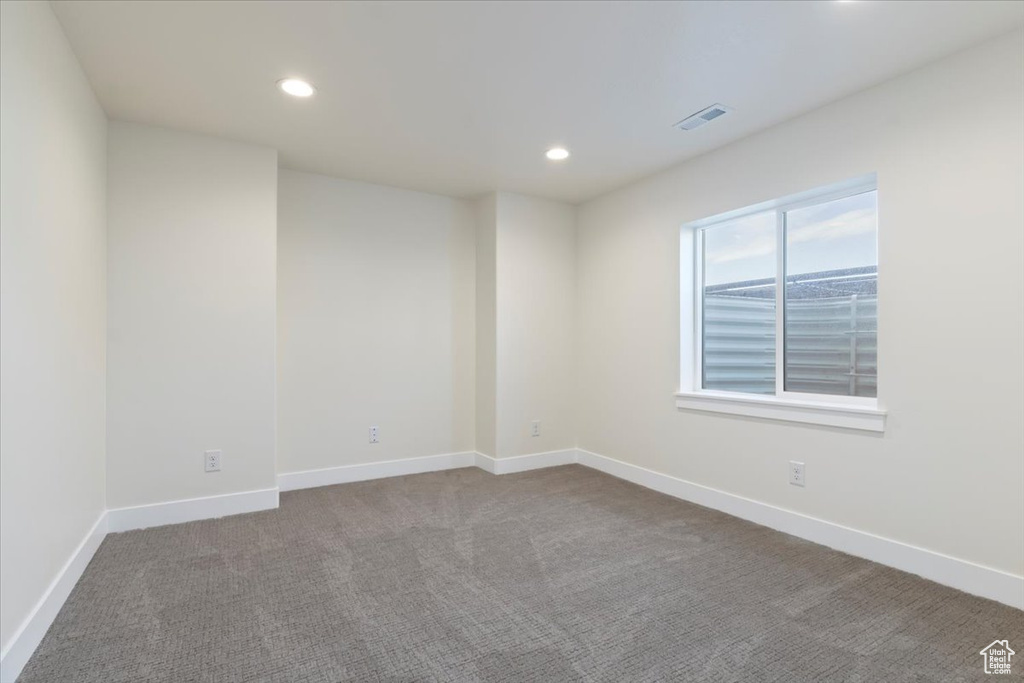 Carpeted empty room featuring recessed lighting and baseboards