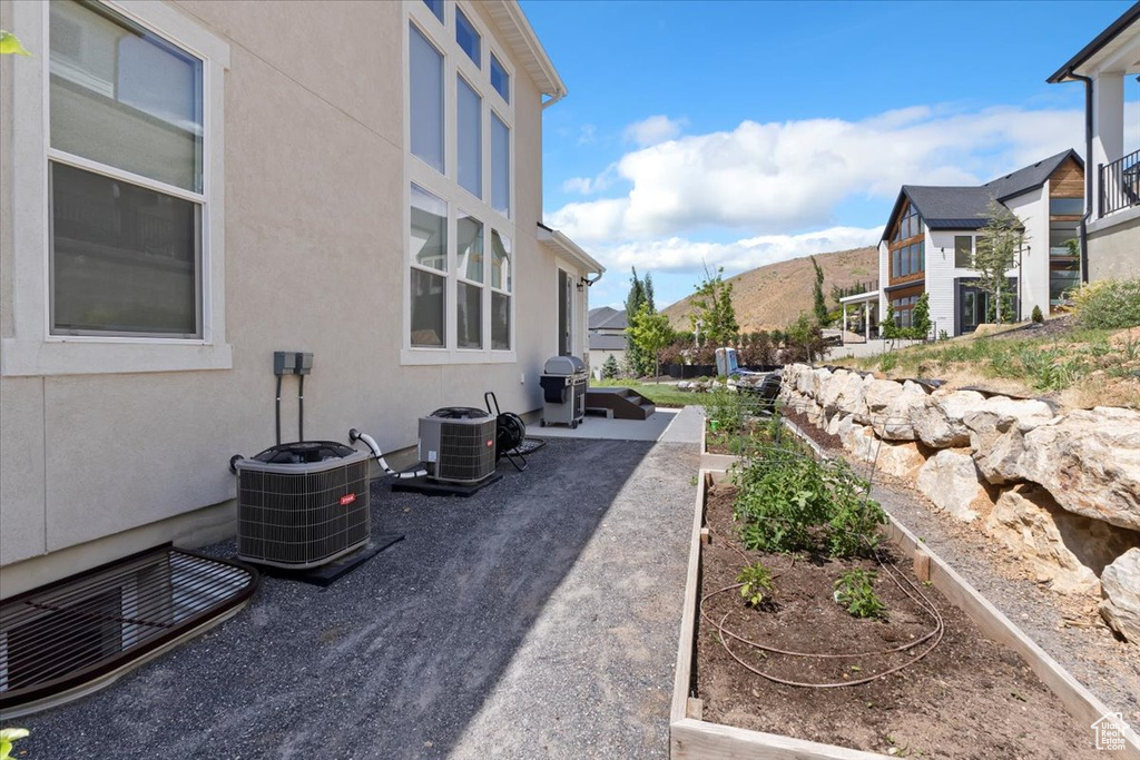 View of yard featuring a patio area, central AC, and a residential view