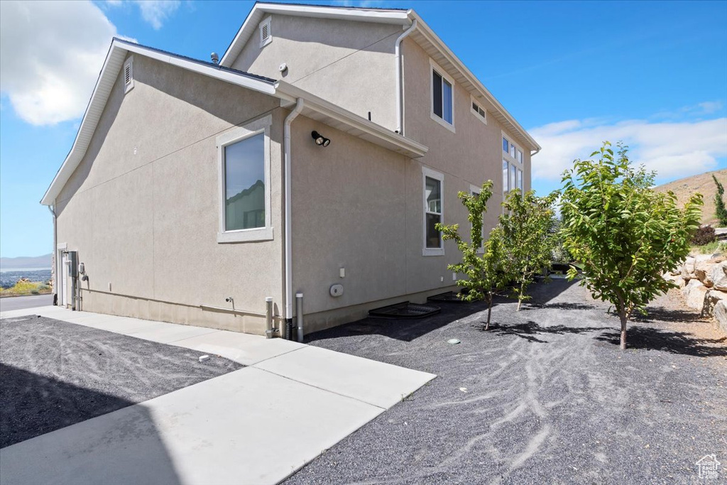 View of side of home featuring stucco siding