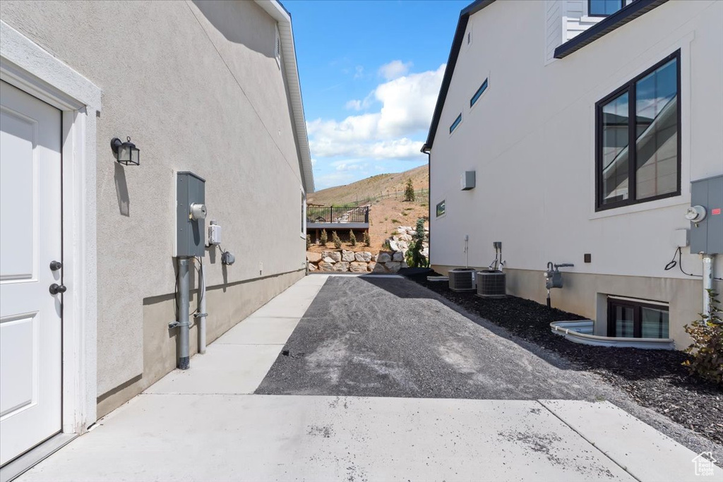 View of side of home featuring stucco siding and a mountain view