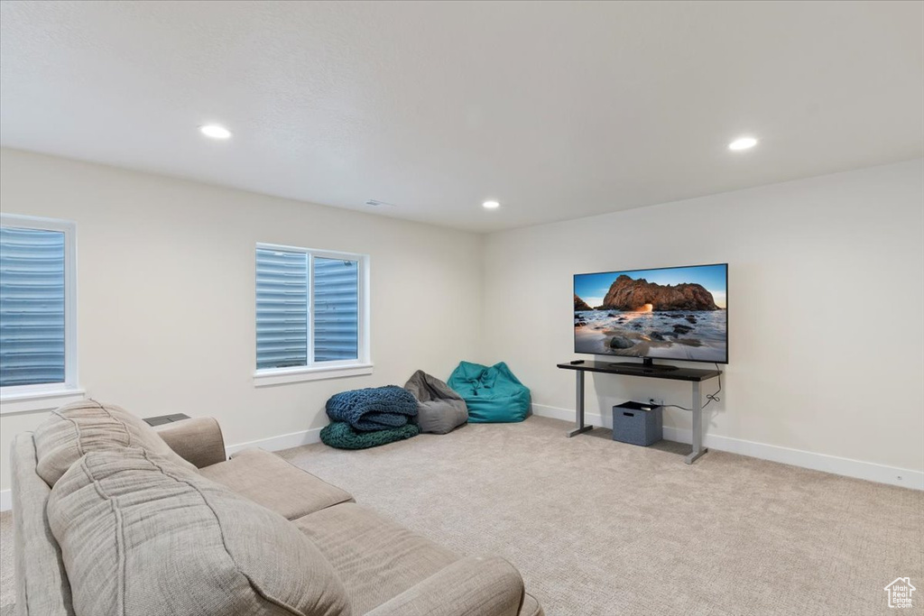 Carpeted living room with recessed lighting and baseboards