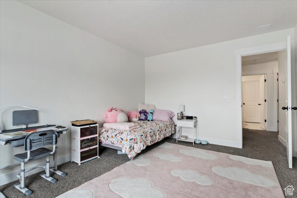 Bedroom featuring carpet and baseboards