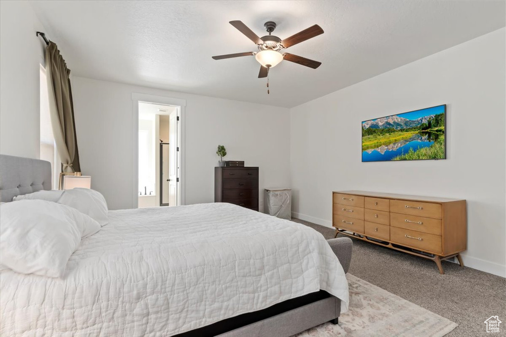 Carpeted bedroom featuring baseboards and a ceiling fan