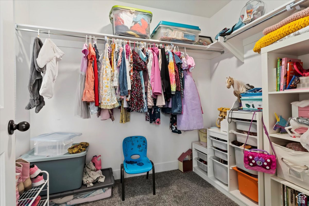Walk in closet featuring carpet flooring