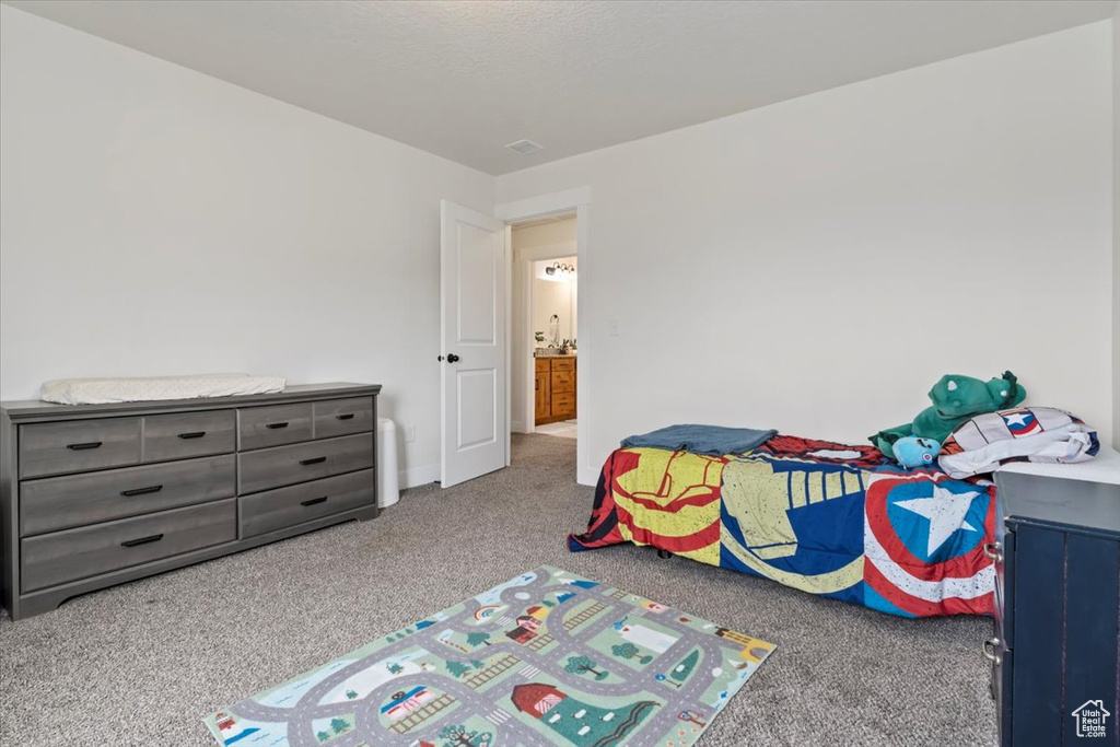 Bedroom featuring carpet floors and baseboards
