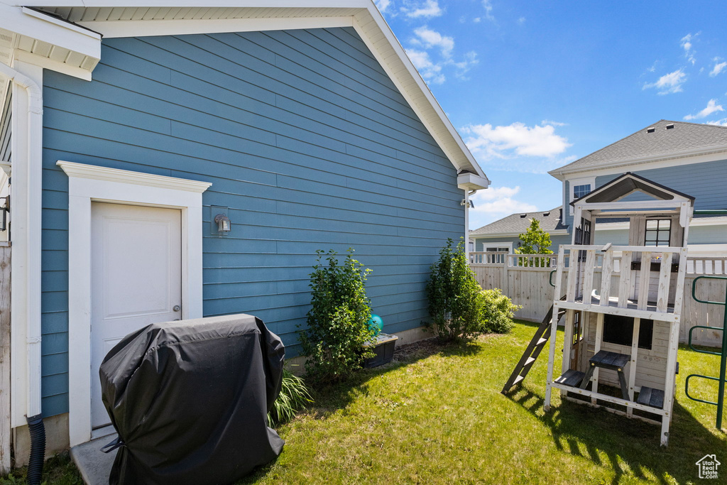 View of side of property with a playground