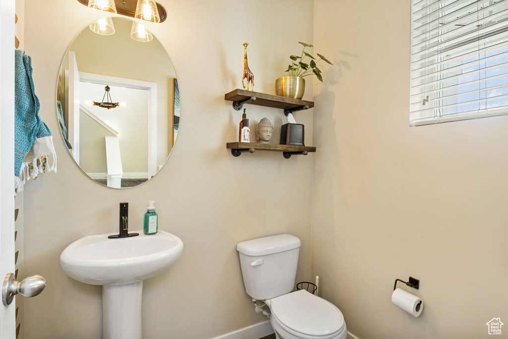 Bathroom featuring toilet and baseboards