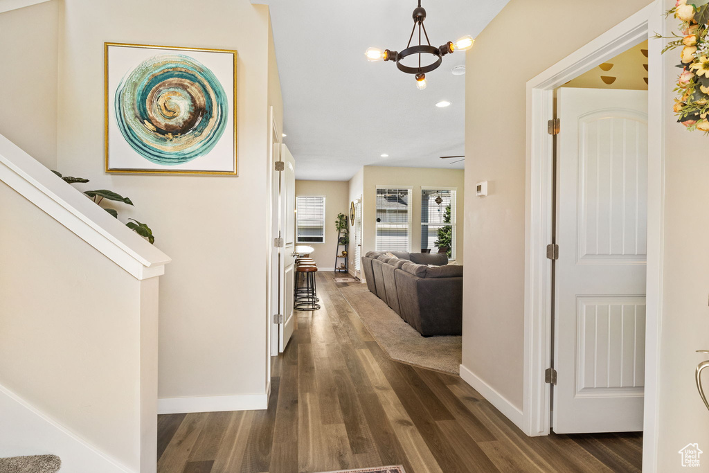 Foyer featuring dark wood-type flooring, baseboards, a chandelier, and recessed lighting