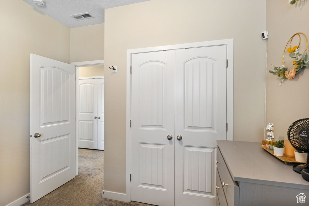 Bedroom featuring carpet, a closet, and baseboards