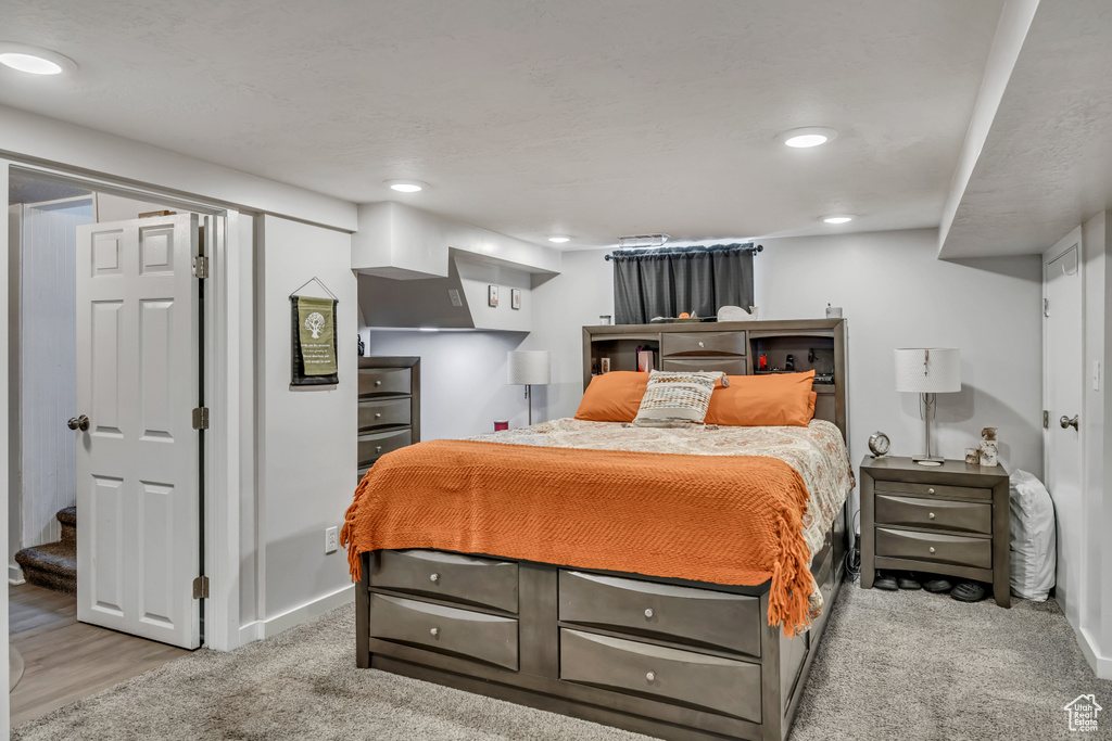 Carpeted bedroom featuring recessed lighting and baseboards