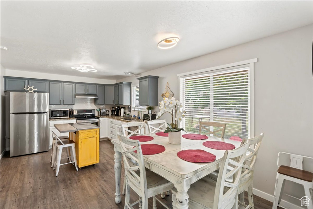 Dining space with dark wood-style flooring