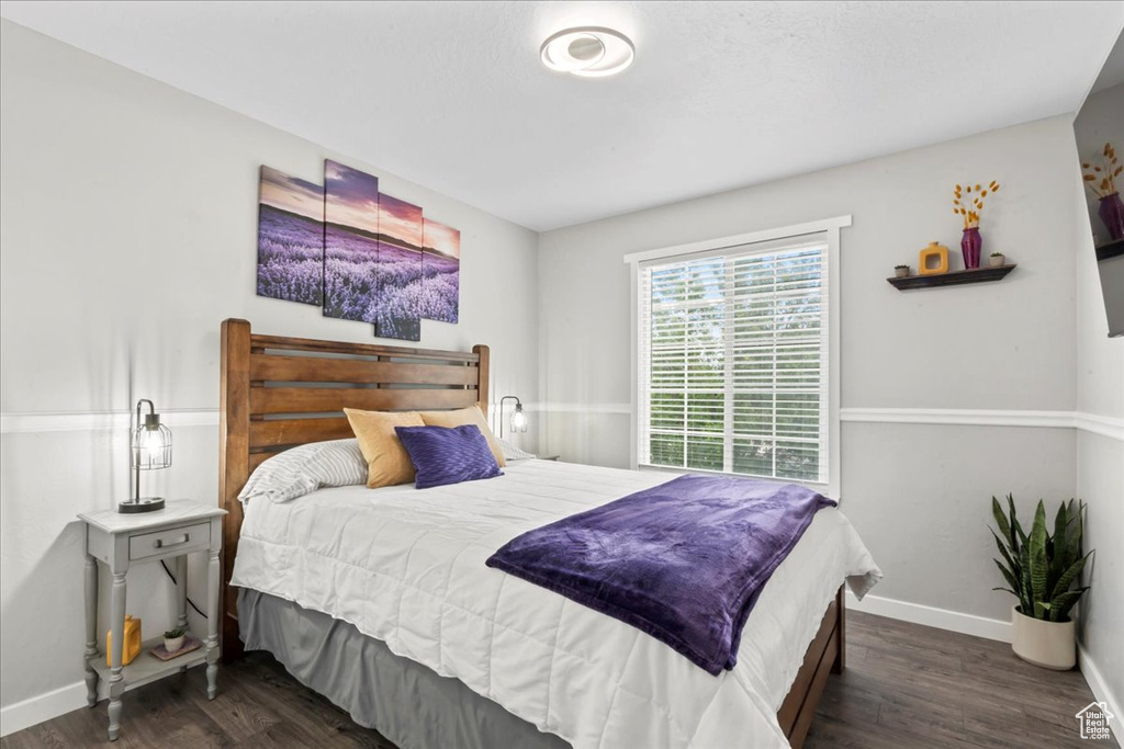 Bedroom featuring wood finished floors and baseboards