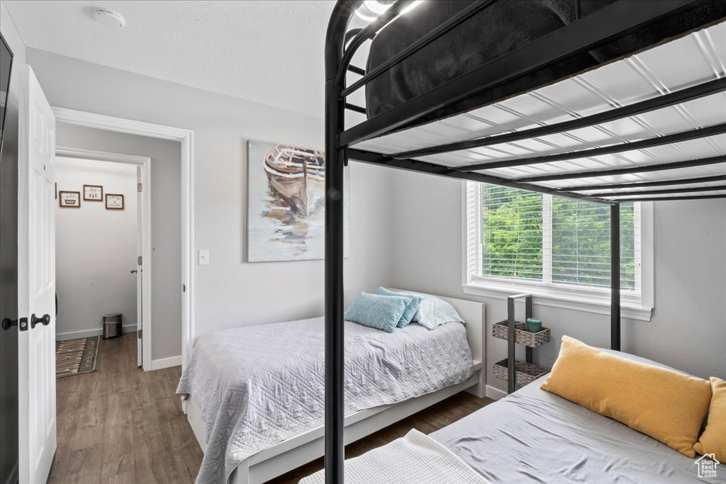 Bedroom featuring wood finished floors and baseboards