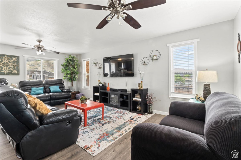 Living area with plenty of natural light, a ceiling fan, and wood finished floors