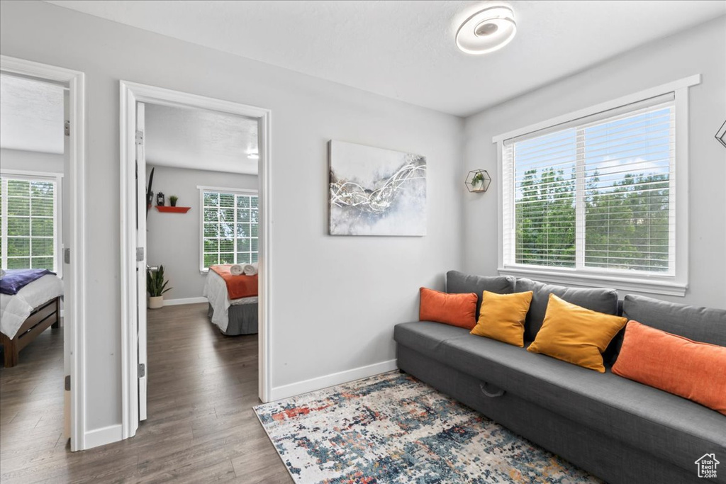 Living area with baseboards and wood finished floors