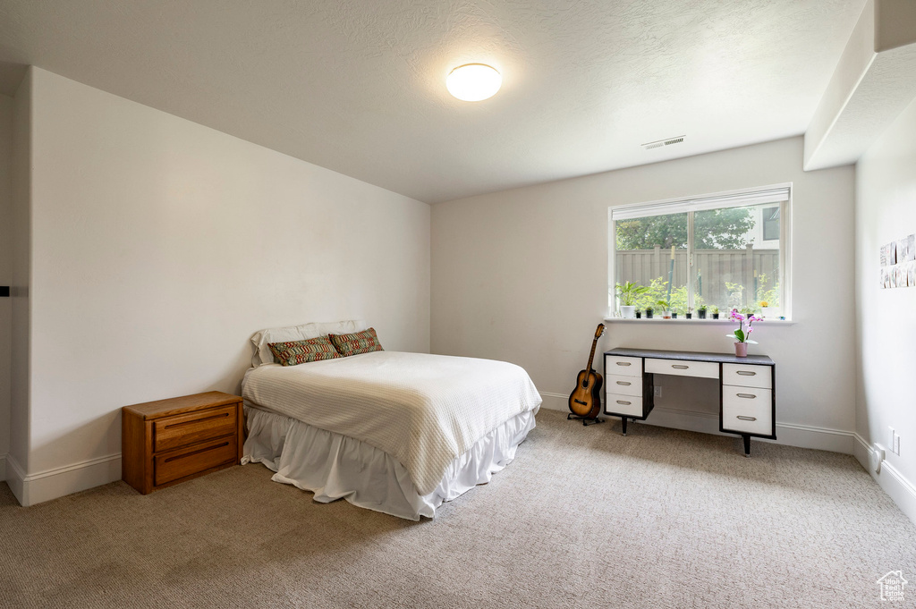 Bedroom with carpet and baseboards
