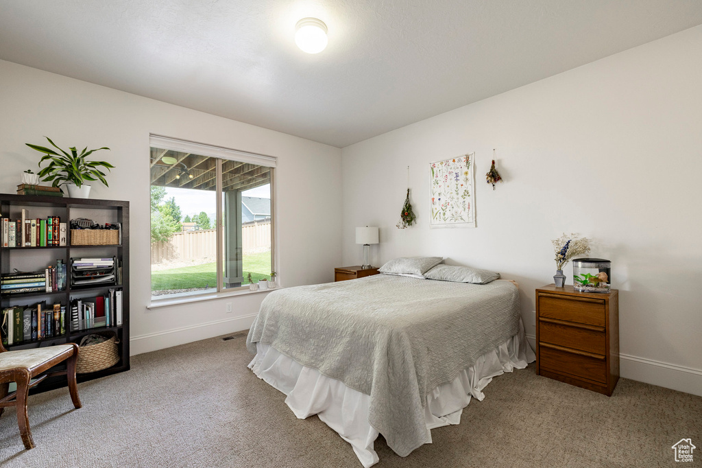 Bedroom featuring light colored carpet and baseboards