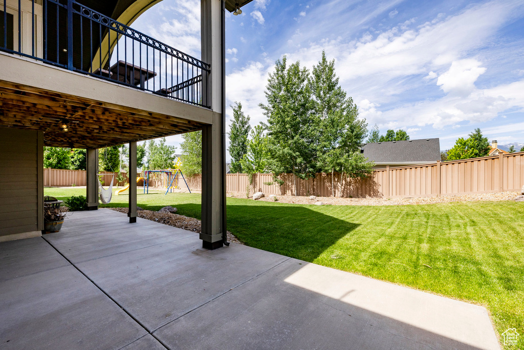 View of patio with a playground