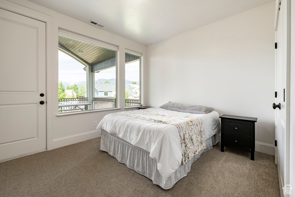 Bedroom featuring light carpet and baseboards