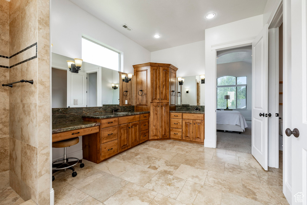 Ensuite bathroom featuring vanity and recessed lighting