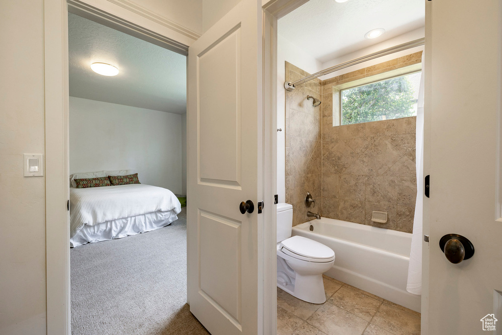 Ensuite bathroom featuring toilet and  shower combination