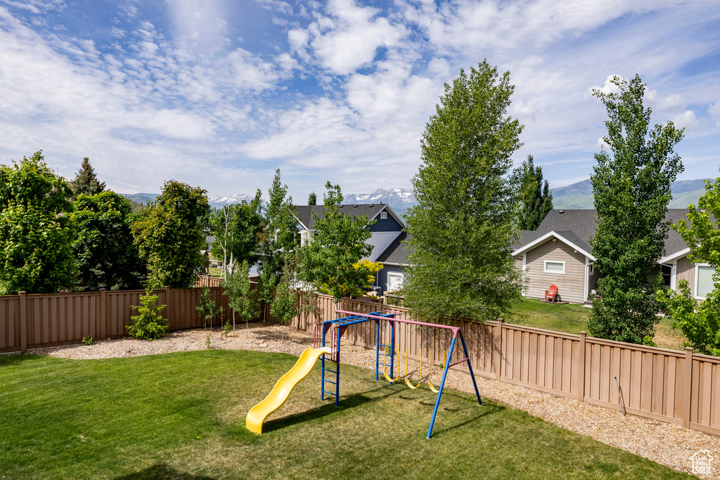 View of yard featuring a playground and a residential view