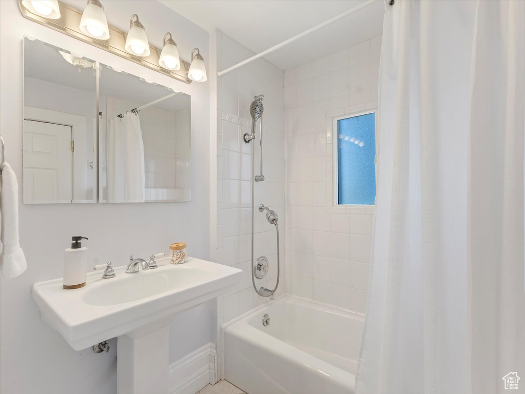 Bathroom with shower / bath combination with curtain