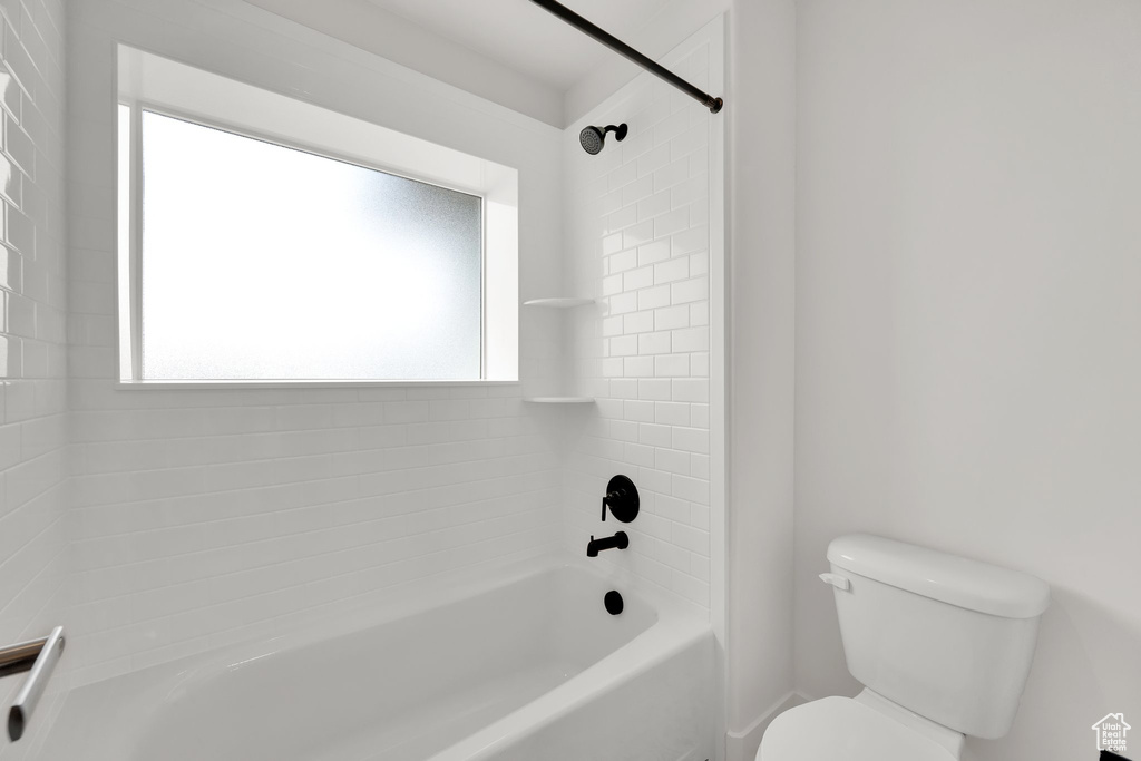 Bathroom featuring toilet and bathtub / shower combination