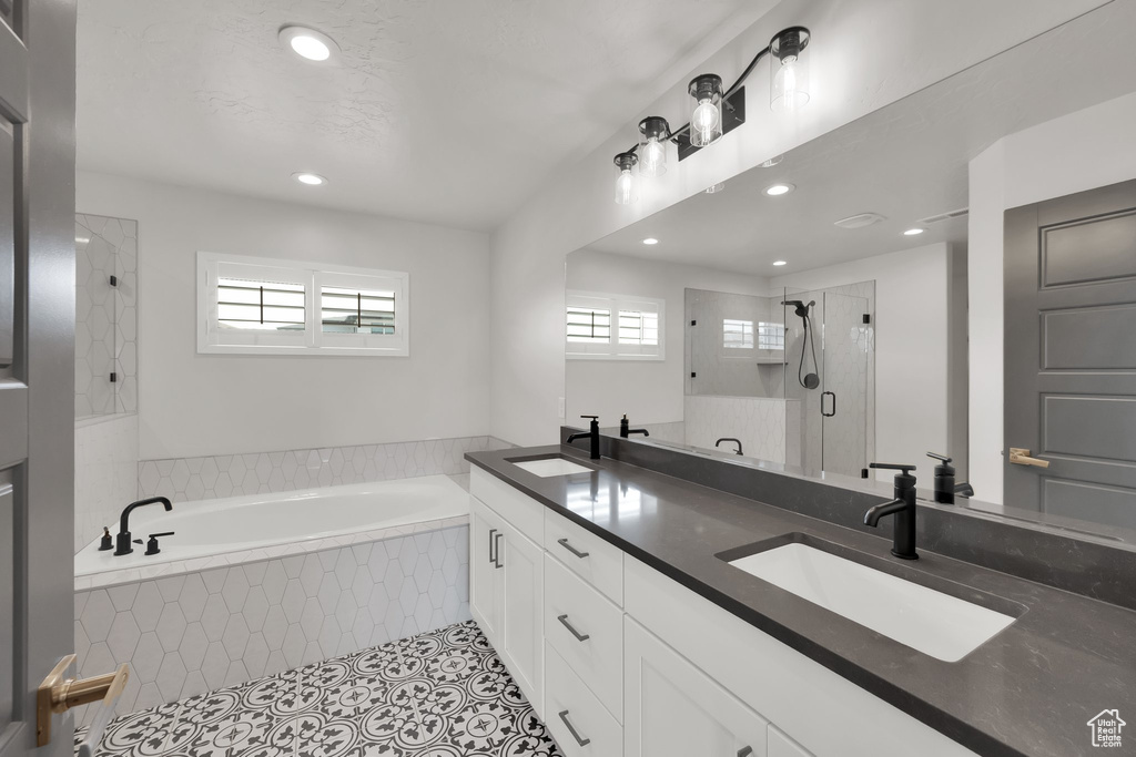 Bathroom with healthy amount of natural light, a garden tub, tile patterned flooring, recessed lighting, and a shower stall