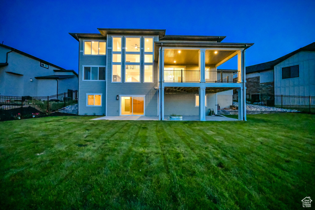 Back of property featuring a patio area and a balcony