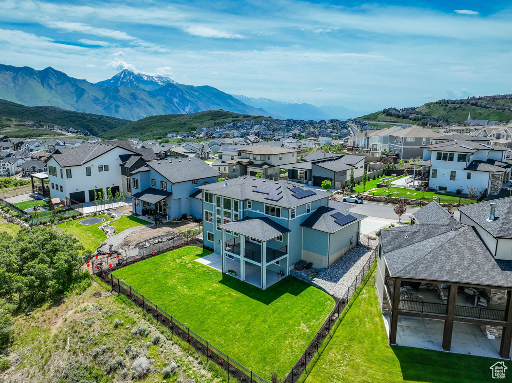 Aerial view of residential area featuring a mountainous background