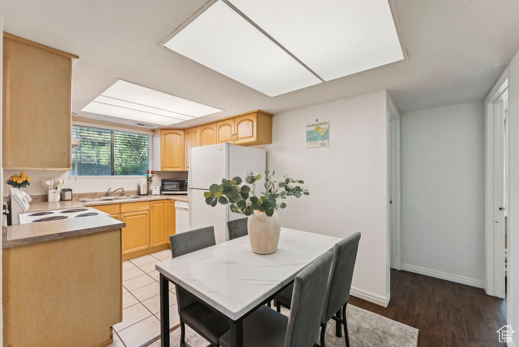 Dining area with light wood-type flooring and baseboards