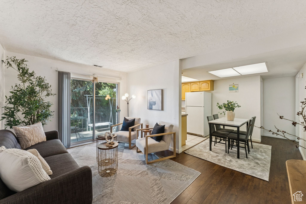 Living room with hardwood / wood-style flooring and a textured ceiling