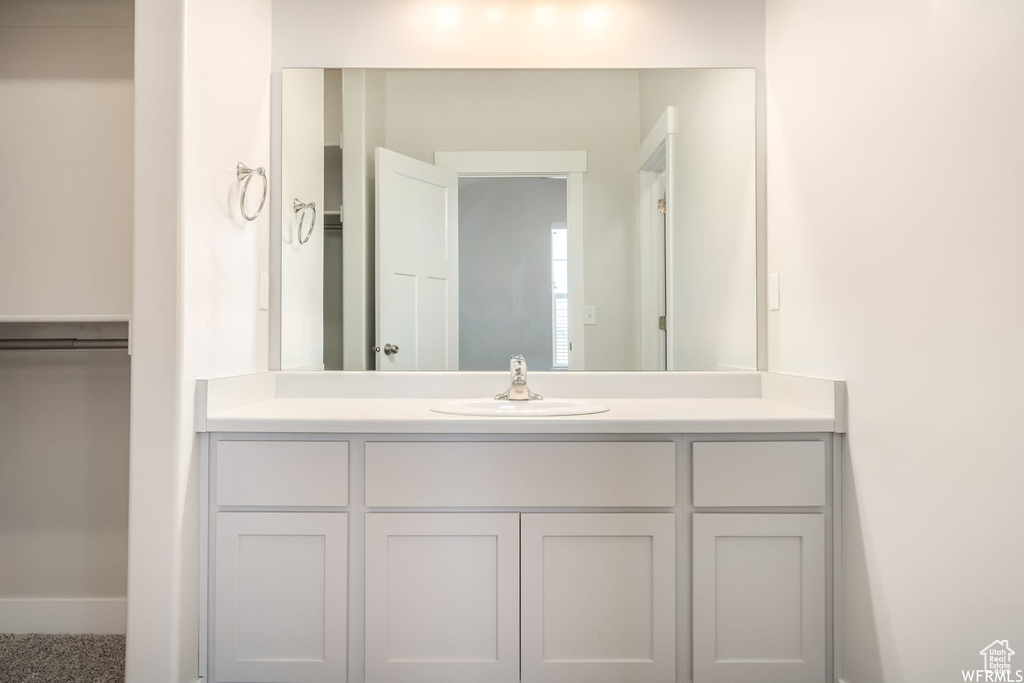 Bathroom with vanity and baseboards
