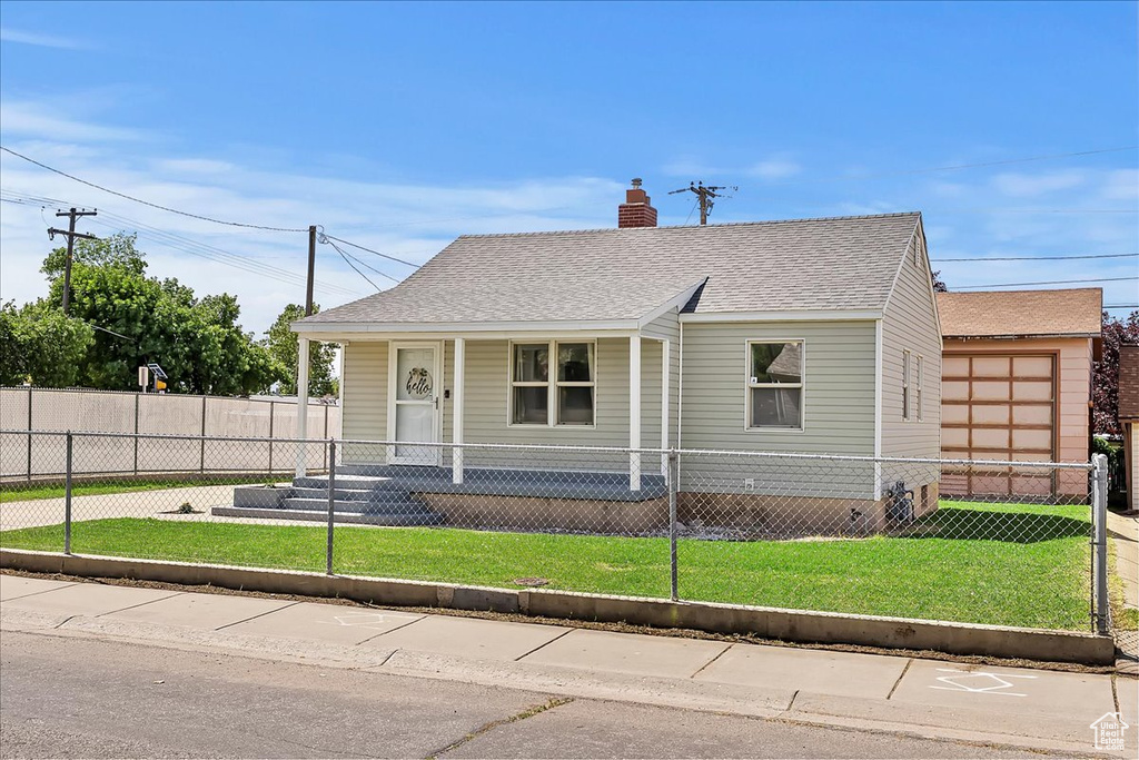 View of front of home with a porch, a chimney, and roof with shingles