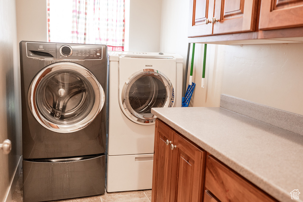 Laundry area with washer and clothes dryer and cabinet space