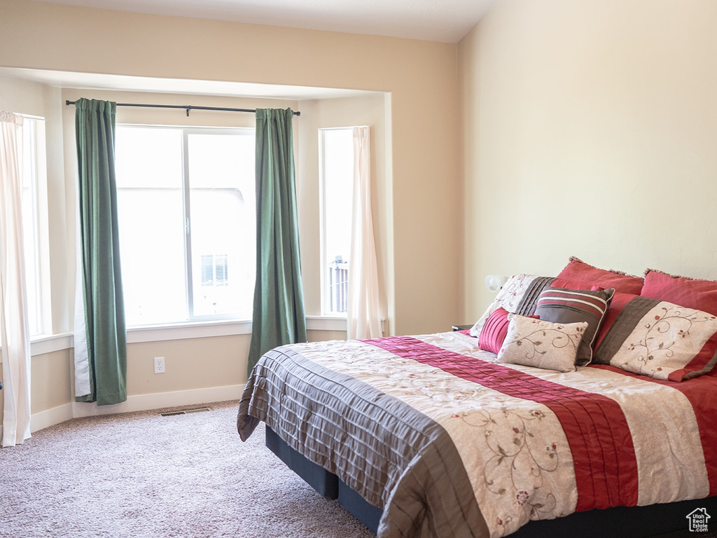 Bedroom with baseboards and carpet floors
