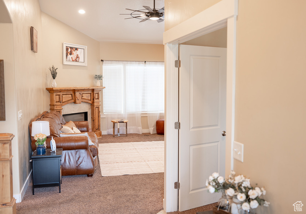 Sitting room featuring carpet, ceiling fan, a fireplace, and recessed lighting
