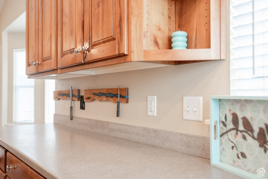Kitchen view of brown cabinets and light countertops