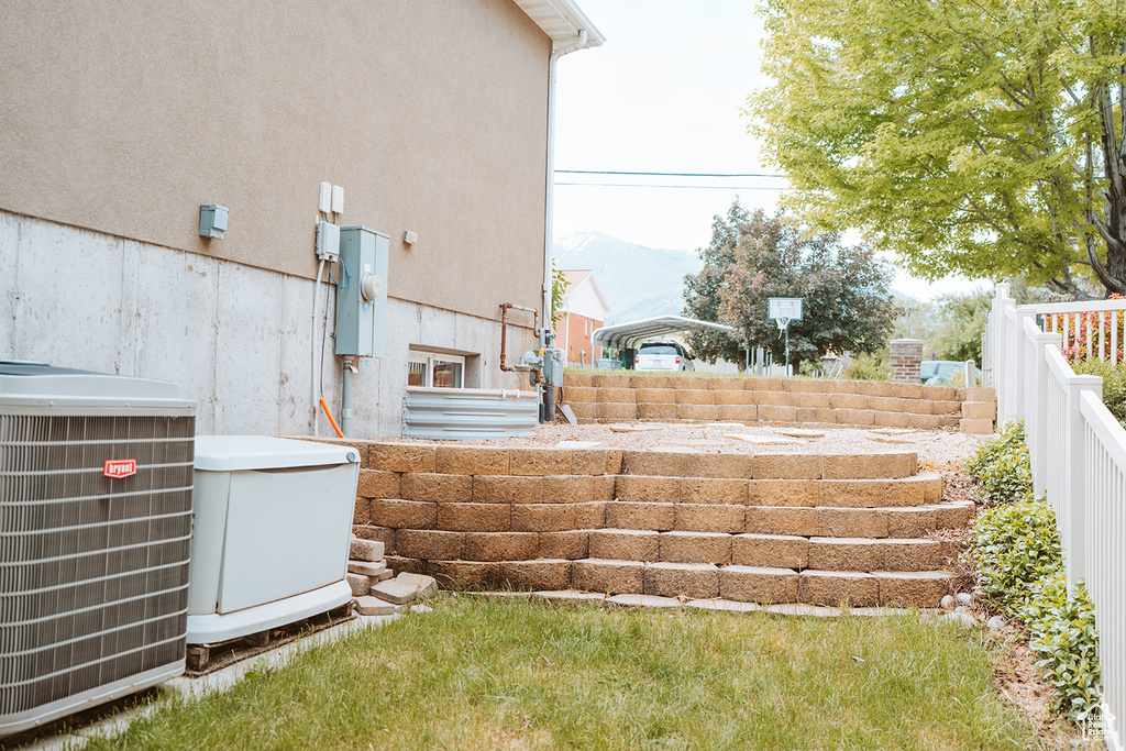 View of yard featuring central AC unit and a mountain view