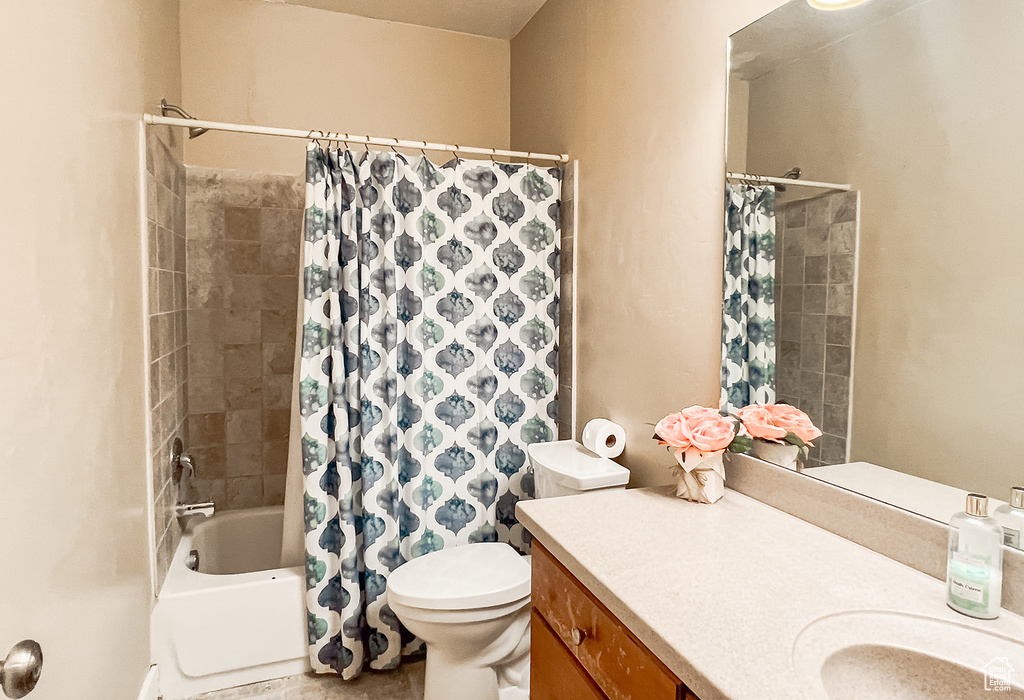 Bathroom featuring vanity, toilet, and shower / bath combo