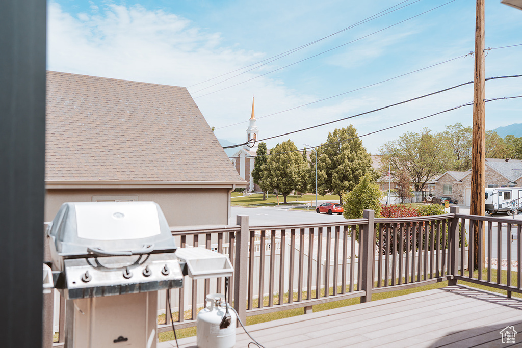 Deck featuring a residential view and a grill