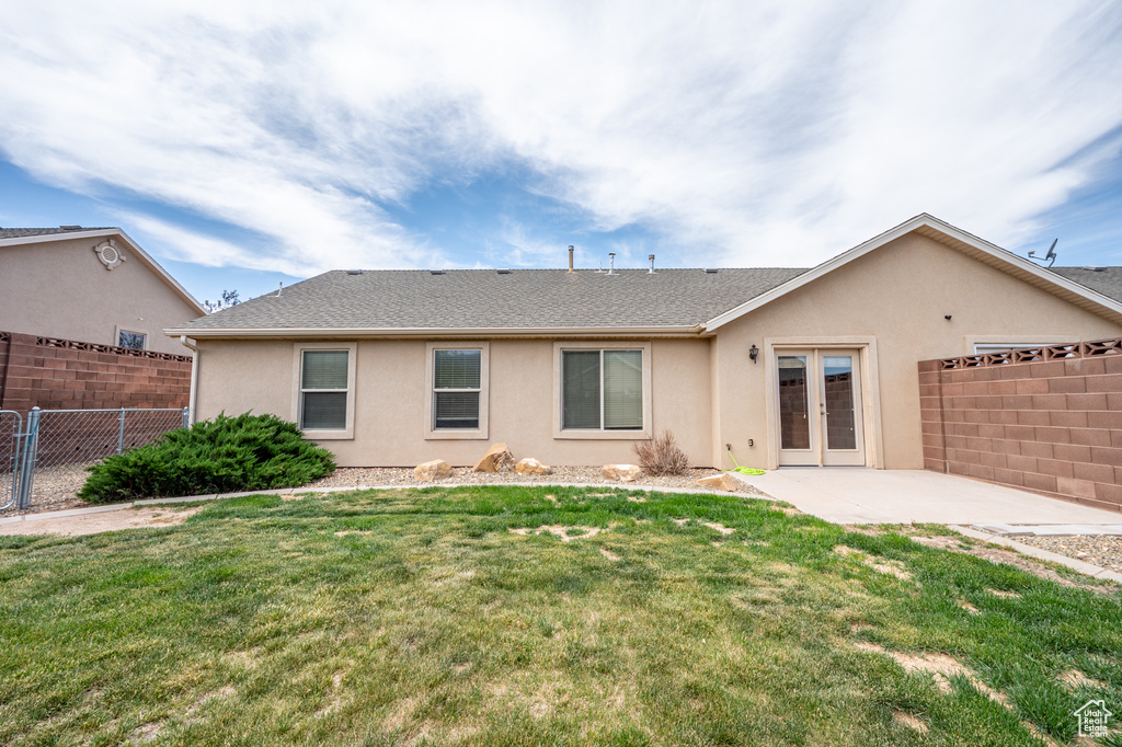 Back of house featuring french doors, stucco siding, a patio, and a shingled roof